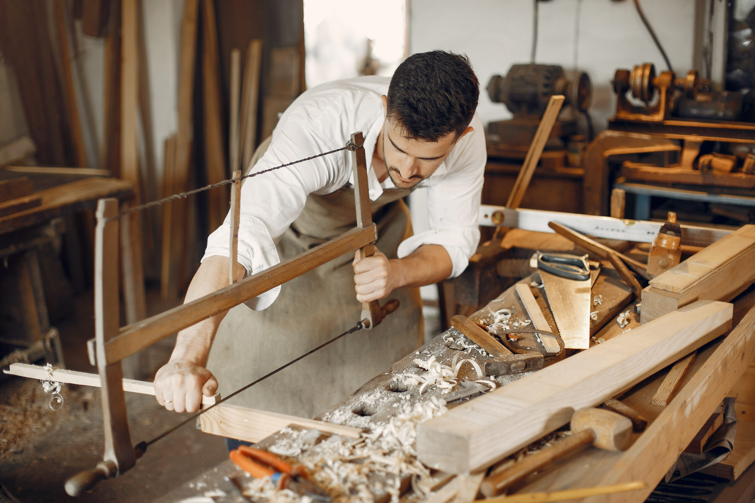Carpentry Services handsome carpenter working with a wood