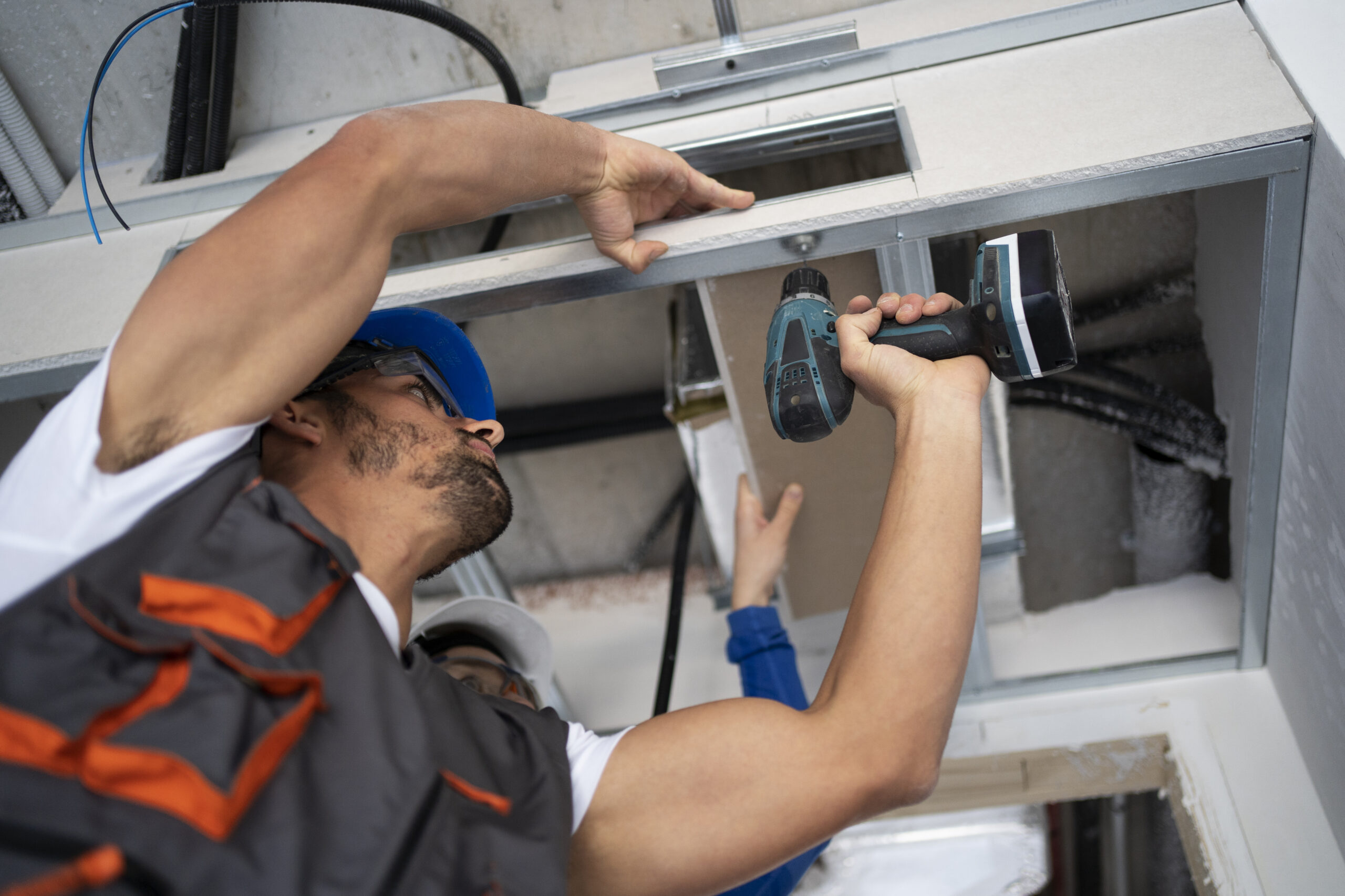 AC Services low angle people working with drill