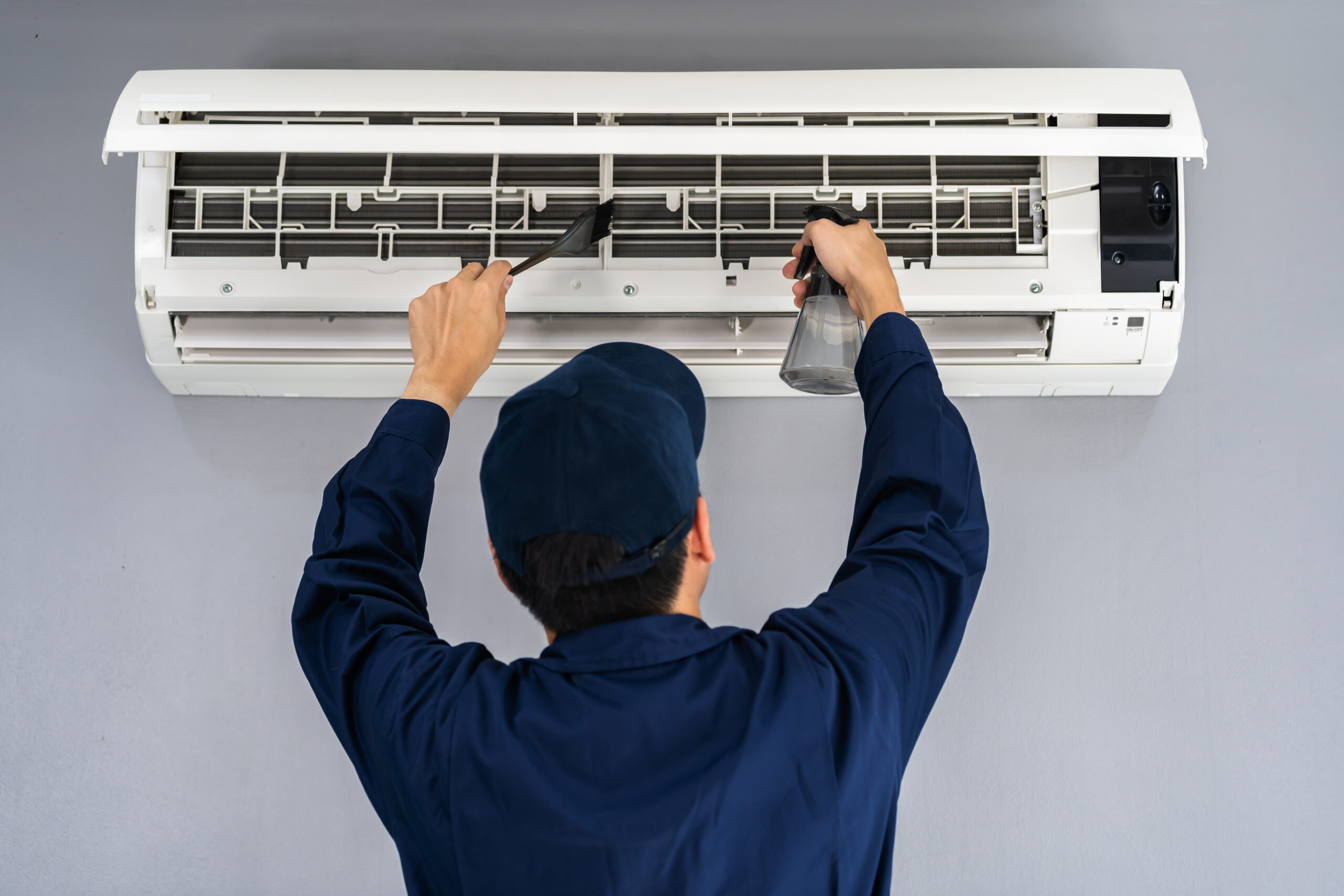 Home technician service cleaning the air conditioner